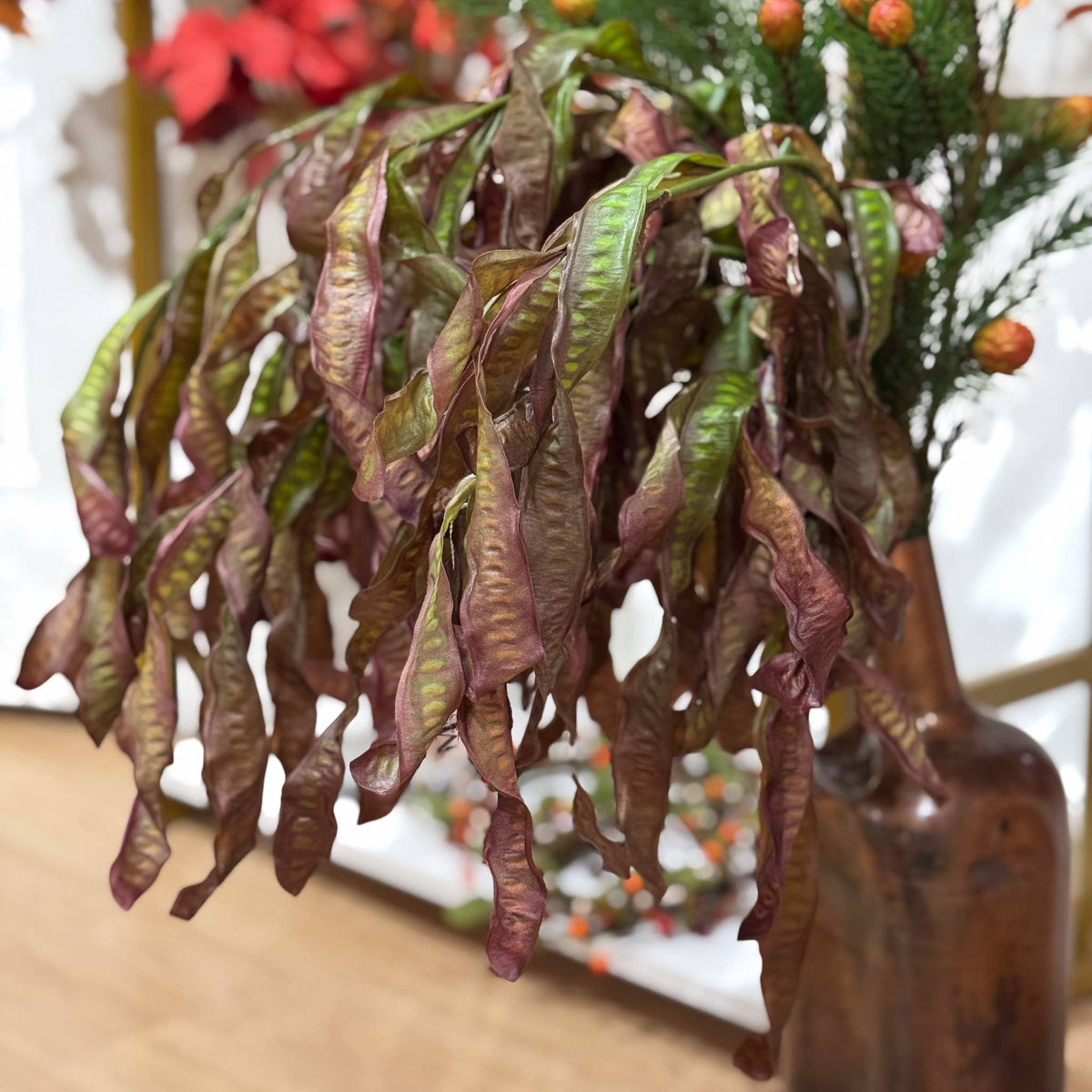 Green and burgundy Hanging Seed Leaves Spray showing long cascading foliage and natural movement