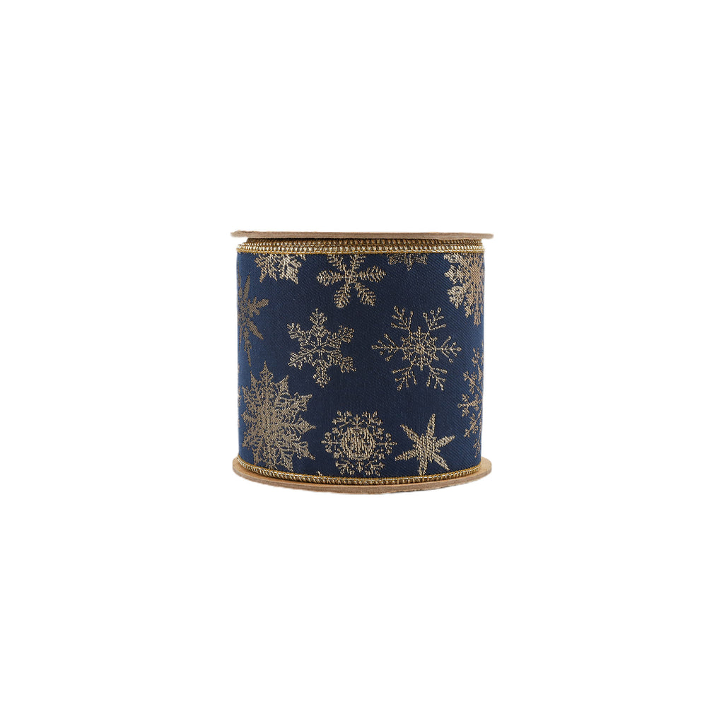 A spool of navy blue ribbon decorated with metallic gold snowflakes, featuring a gold braided edge.