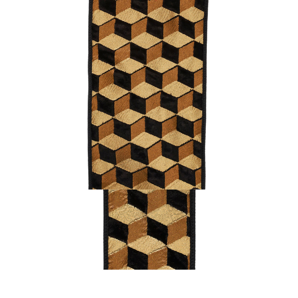 A close-up of a woven textile featuring a 3D cube optical illusion pattern in black, tan, and brown, shown against a plain white background.