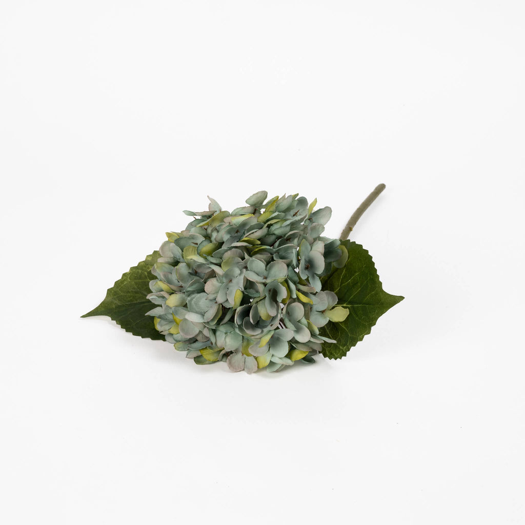 Blue artificial hydrangea bloom showing antiqued blue-green petals and layered texture